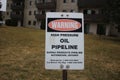Petroleum pipeline warning sign in green grassy meadow.