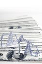 Petroleum pumpjack and oil rigs from paper on a heap of 100 dollar bills. Shallow focus. Royalty Free Stock Photo