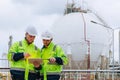 Petroleum tank engineer working together, Engineering teamwork work against oil gas storage tank field Royalty Free Stock Photo