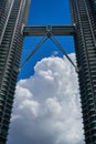 Petronas Twin Towers KLCC and sky bridge over deep blue sky and big cloud Royalty Free Stock Photo