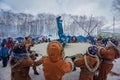 Petropavlovsk-Kamchatsky, Russia - February 22, 2021: Koryaks in traditional clothes rock a child on a canvas