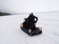 Petrozavodsk, Republic of Karelia / Russia - November 10, 2019: women ride a snowmobile on a frozen lake. In the background are