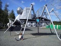 Petrozavodsk, Russia - August 18, 2019 A blond-haired boy in a blue T-shirt climbed onto a metal structure. An old tractor with Royalty Free Stock Photo