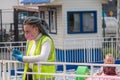 An amusement Park worker pulls out a stuck boat with a child