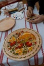 Petrykivka painting style wooden plate, typical Ukrainian retro landscape, man`s hands handpainting