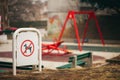 Pets no pooping sign in front of children playground