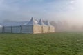 Marquees in the morning mist.