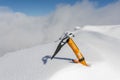 Petzl Gully ice axe in the snow on a peak in the mountains Royalty Free Stock Photo