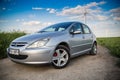 Peugeot car on a field with windmills Royalty Free Stock Photo