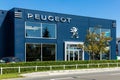Peugeot chrome logo sign on the building of a car dealer in Montfoort. Peugeot is a French car producer.