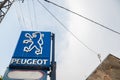 Peugeot logo on an old sign of a car dealership of the brand, with its distinctive Lion.