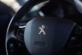 Peugeot logo on the steering wheel. Peugeot dashboard interior.