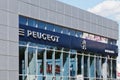 Peugeot sign on building of service center.