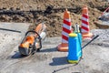 Peyrol disc cutter with a hand pump for water supply when the disc is working against the backdrop of the workplace on a sunny day