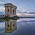 Peyrou Pavilion in Montpellier with reflection and sunset colors