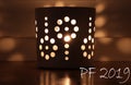 PF 2019 greeting card with candle in cup with a holes which divide the light into many beautiful shades. Wish you all the best