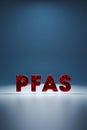 PFAS red sign on a blue background - crashing in a small particles conceptual 3D render