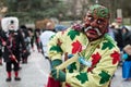 people with monster mask parading in the street