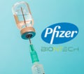 Pfizer and BioNTech logos on blue background, Covid19 vaccine vial and syringe, Coronavirus immunization