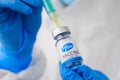 Pfizer coronavirus Vaccine and syringe in the bottle or vial for injection in doctors hands. Covid-19, SARS-Cov-2