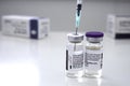 Pfizer COVID-19 vaccine vials bottles with a syringe