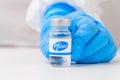 Pfizer vial or bottle with pharmaceuticals demonstrated by health worker or scientist in rubber gloves, April 2021, San