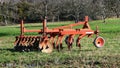 A plow on a green meadow