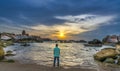 The lonely man watches the sunrise on a sandy beach Royalty Free Stock Photo