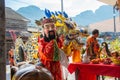 Phang Nga, Thailand - October 15, 2018: Man in Chinese costume with God mask together with dragon blessing people who pay respect