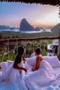 Phangnga Bay Thailand, couple in bed waking up in the jungle of Phangnga Bay looking out over the ocean and Island of