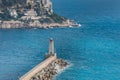 Landmark and architecture: Phare de Nice (Nice Lighthouse) as the waves smash into the pier of Port Lympia Royalty Free Stock Photo