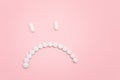 Pharma Harm. Sad Smiley Face Made from White Pills