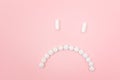 Pharma Harm. Sad Smiley Face Made from White Pills