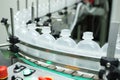 Pharmaceutical industry, medicine pills are filling in the plastic bottle on production line machine conveyor at the Royalty Free Stock Photo