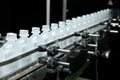 Pharmaceutical industry, medicine pills are filling in the plastic bottle on production line machine conveyor at the Royalty Free Stock Photo