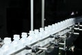 Pharmaceutical industry, medicine pills are filling in the plastic bottle on production line machine conveyor at the Royalty Free Stock Photo