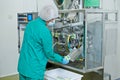 Pharmaceutical industry. technician works with medicine packing machine Royalty Free Stock Photo