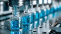 Pharmaceutical manufacturing process with blue liquid in glass vials Royalty Free Stock Photo