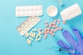 pills, syringe, gloves on a blue background Royalty Free Stock Photo