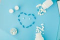 Pharmaceutical medicine pills, tablets and capsules in the shape of a heart on a blue background Royalty Free Stock Photo