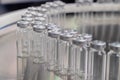 Pharmaceutical production line - conveyor belt with empty injection glass vials Royalty Free Stock Photo