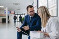 Pharmaceutical sales representative talking with doctor in clinic lobby. Ambitious male sales representative presenting Royalty Free Stock Photo