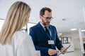 Pharmaceutical sales representative talking with doctor in medical building. Ambitious male sales representative Royalty Free Stock Photo