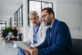 Pharmaceutical sales representative talking with doctor in medical building. Ambitious male sales representative Royalty Free Stock Photo