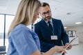 Pharmaceutical sales representative talking with doctor, presenting new medication. Nurse talking with hospital director Royalty Free Stock Photo