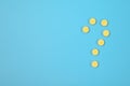 Pharmaceuticals, question mark made of pills and a bottle on a blue background. Copy space for text Royalty Free Stock Photo