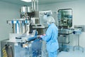 Pharmaceutics. Pharmaceutical worker operates blister packaging machine Royalty Free Stock Photo