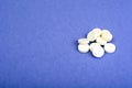 Pharmaceutics. White pills on violet background Royalty Free Stock Photo