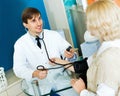 Pharmaceutist taking mature patients blood pressure using sphy Royalty Free Stock Photo