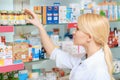 Pharmacist arranging medicines on the shelves Royalty Free Stock Photo